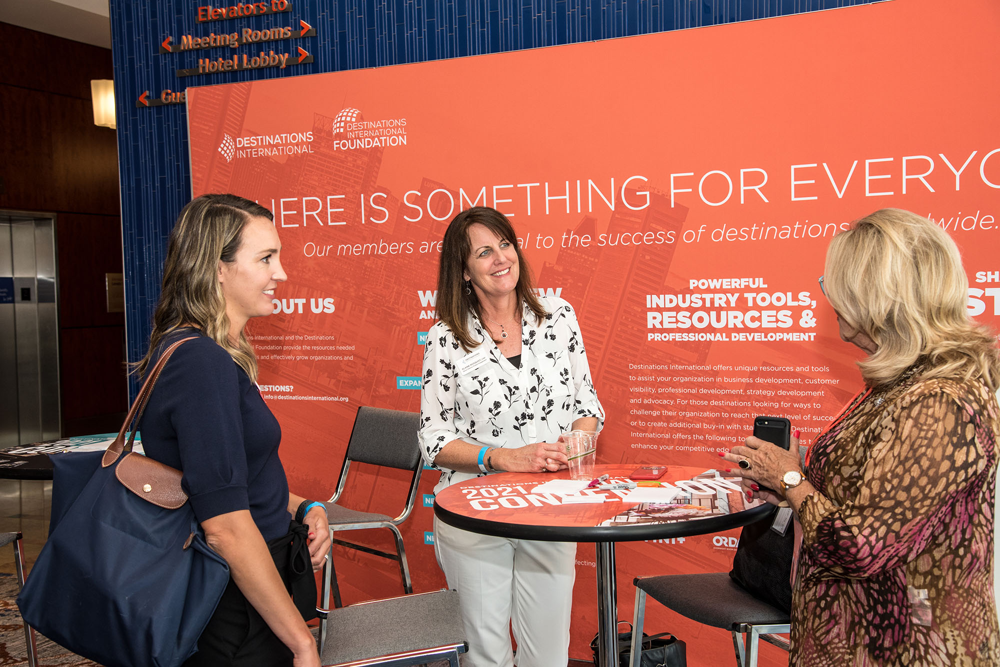 Elaine Rosquist and Kim Bach talking to a member at 2021 Annual Convention