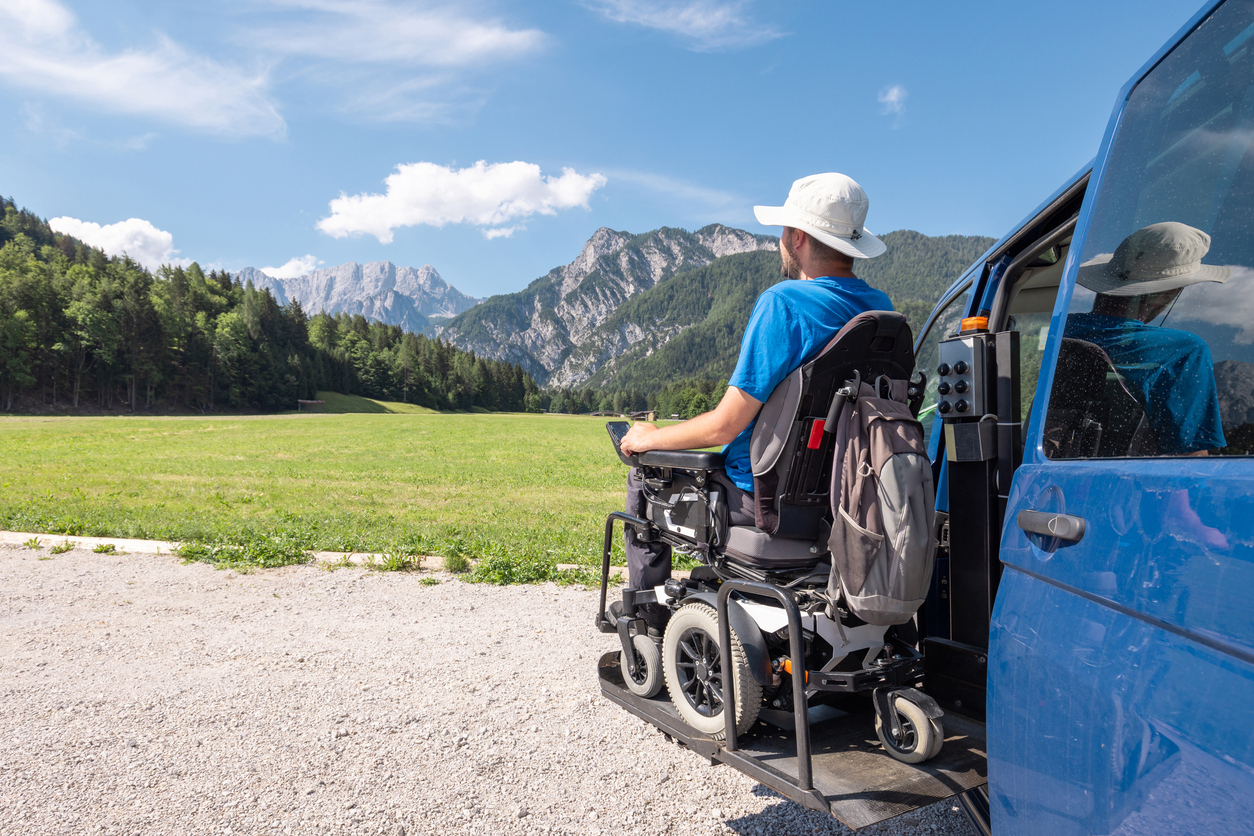 Man in wheelchair admiring view of mountains