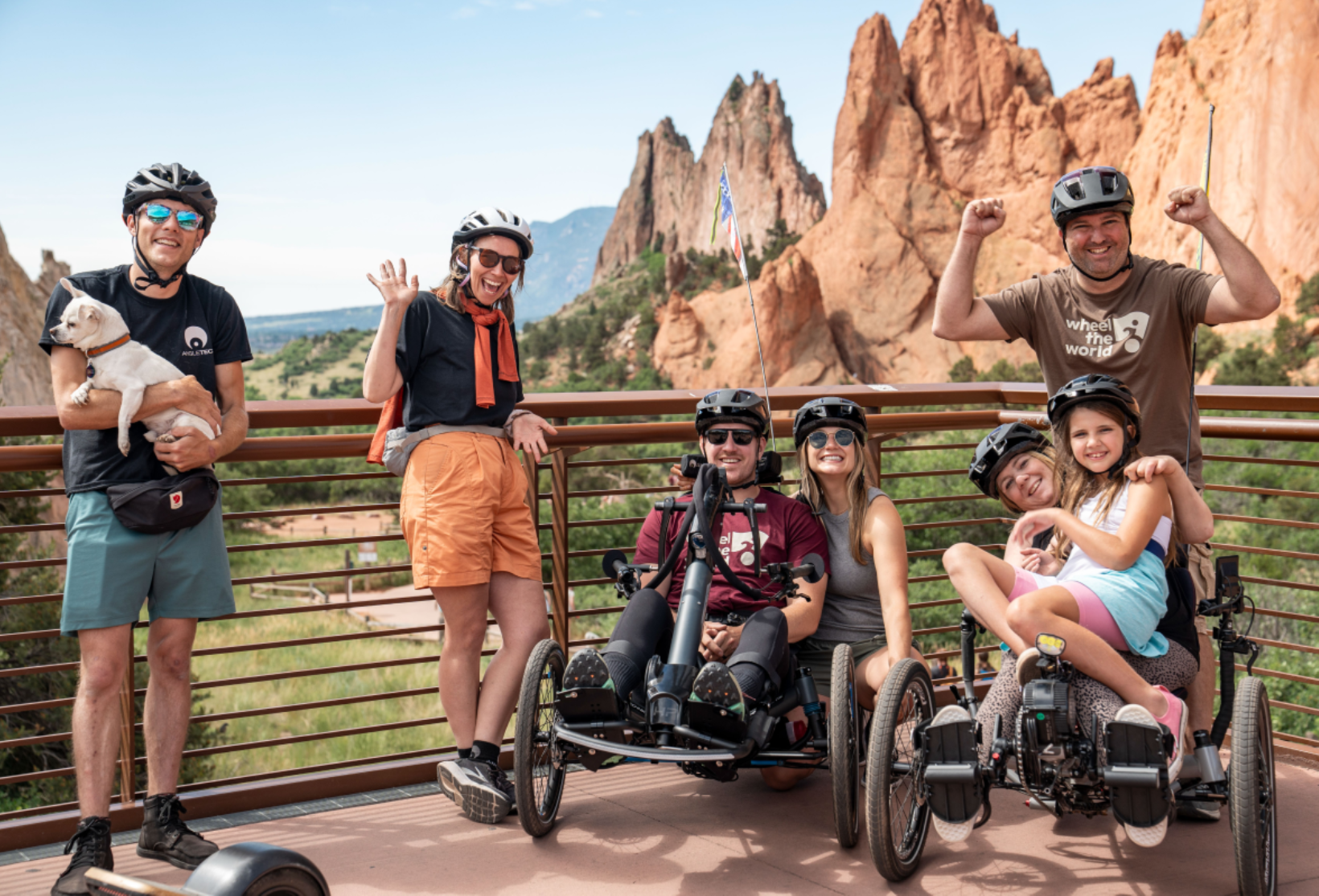 travelers posing in front of red rocks