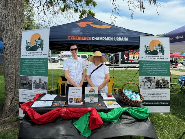2 workers at the Experience Champaign Urbana booth