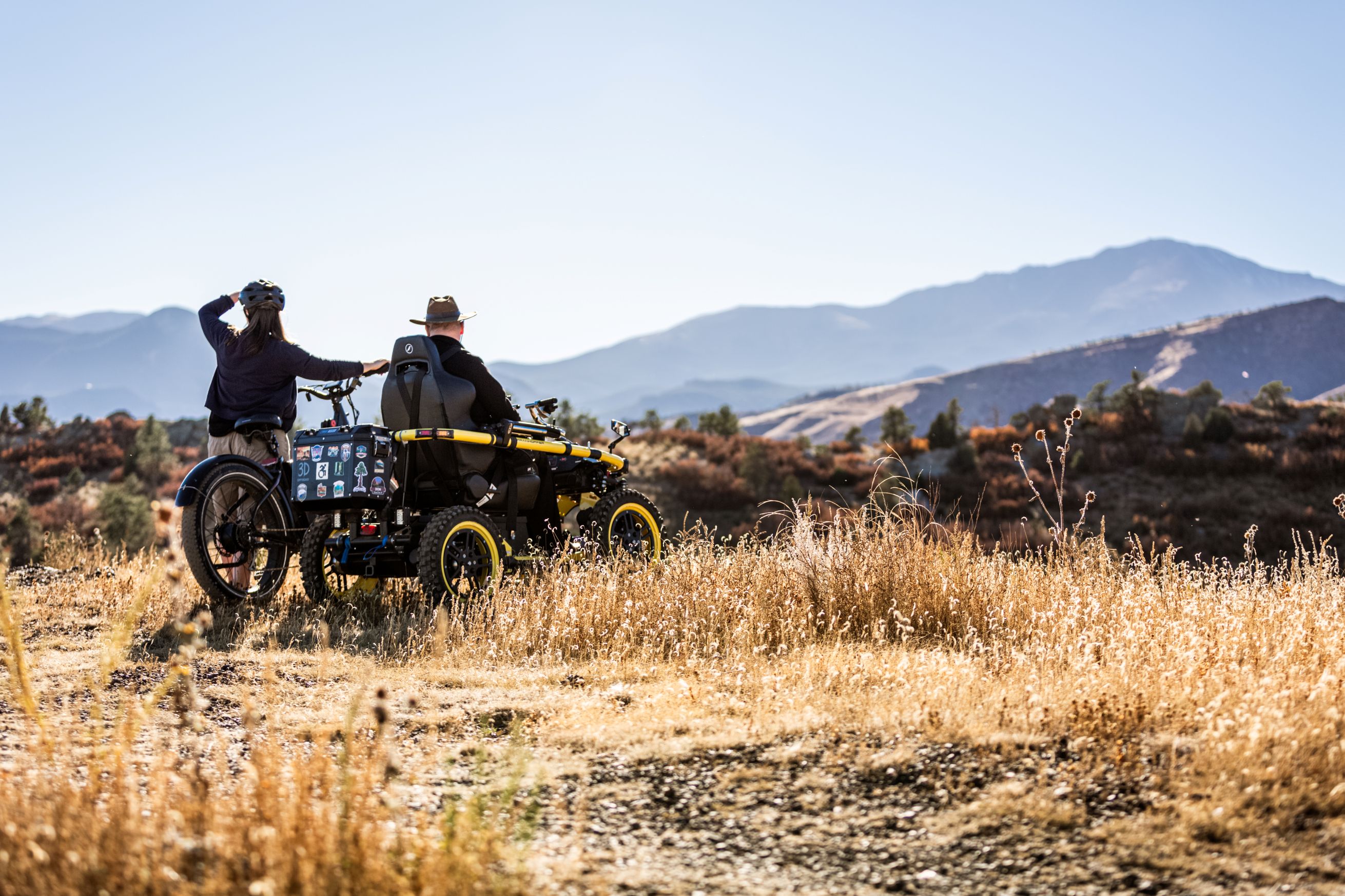 two people overlooking the view of a mountain