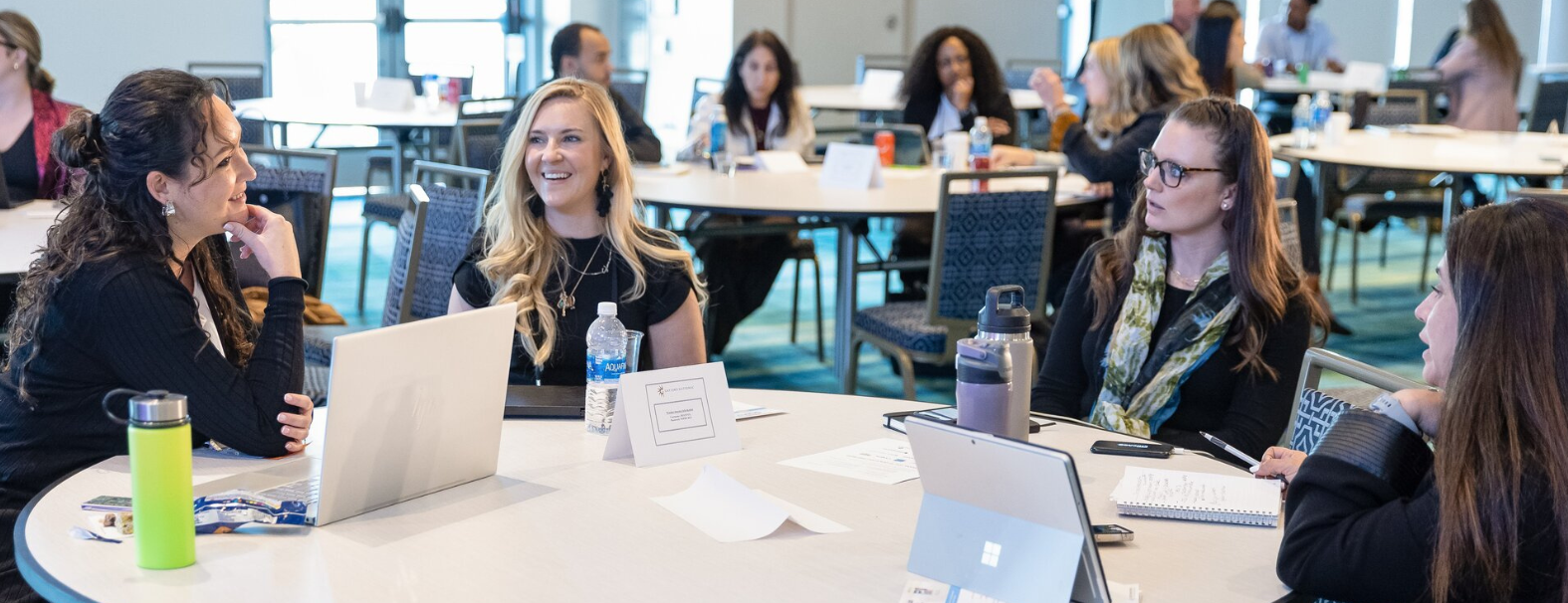 group of event attendees talking at a roundtable