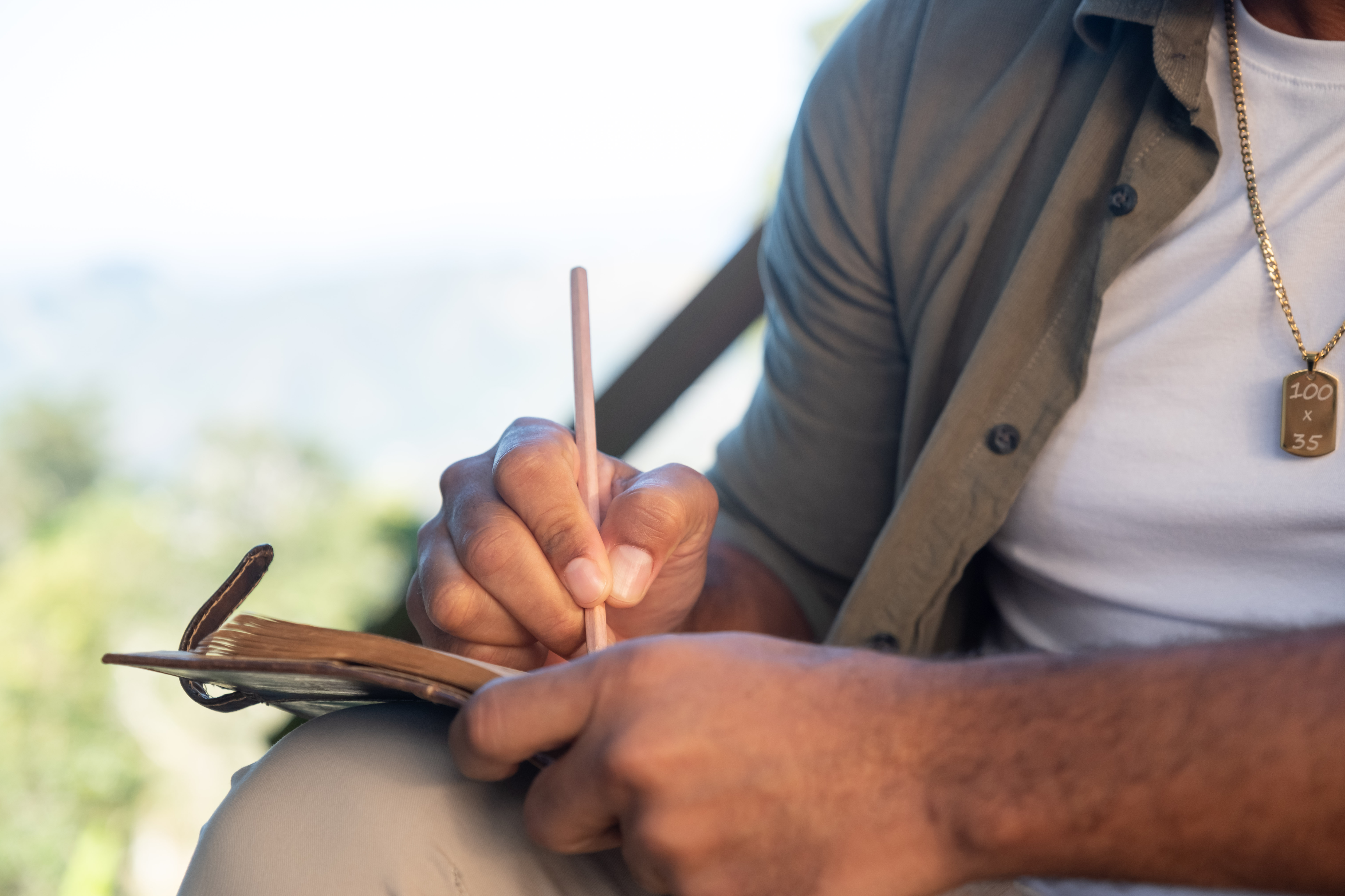 a man writes in a notebook