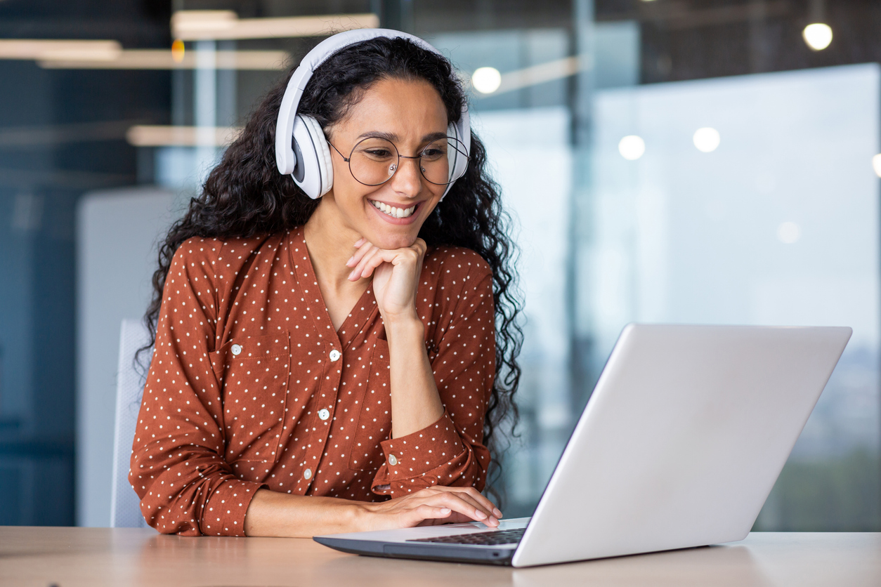 woman wearing headphones watching something on her computer