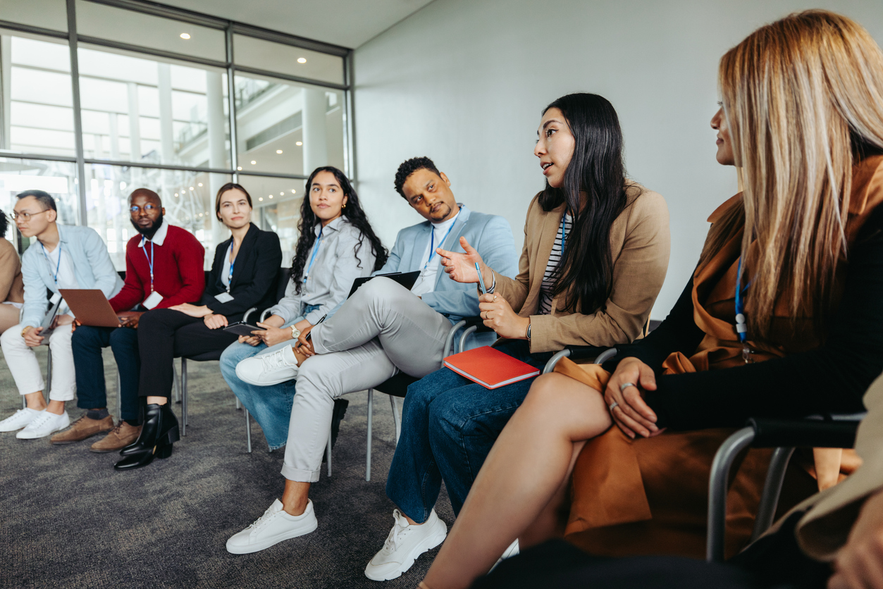 group of coworkers looking at their colleague who is speaking