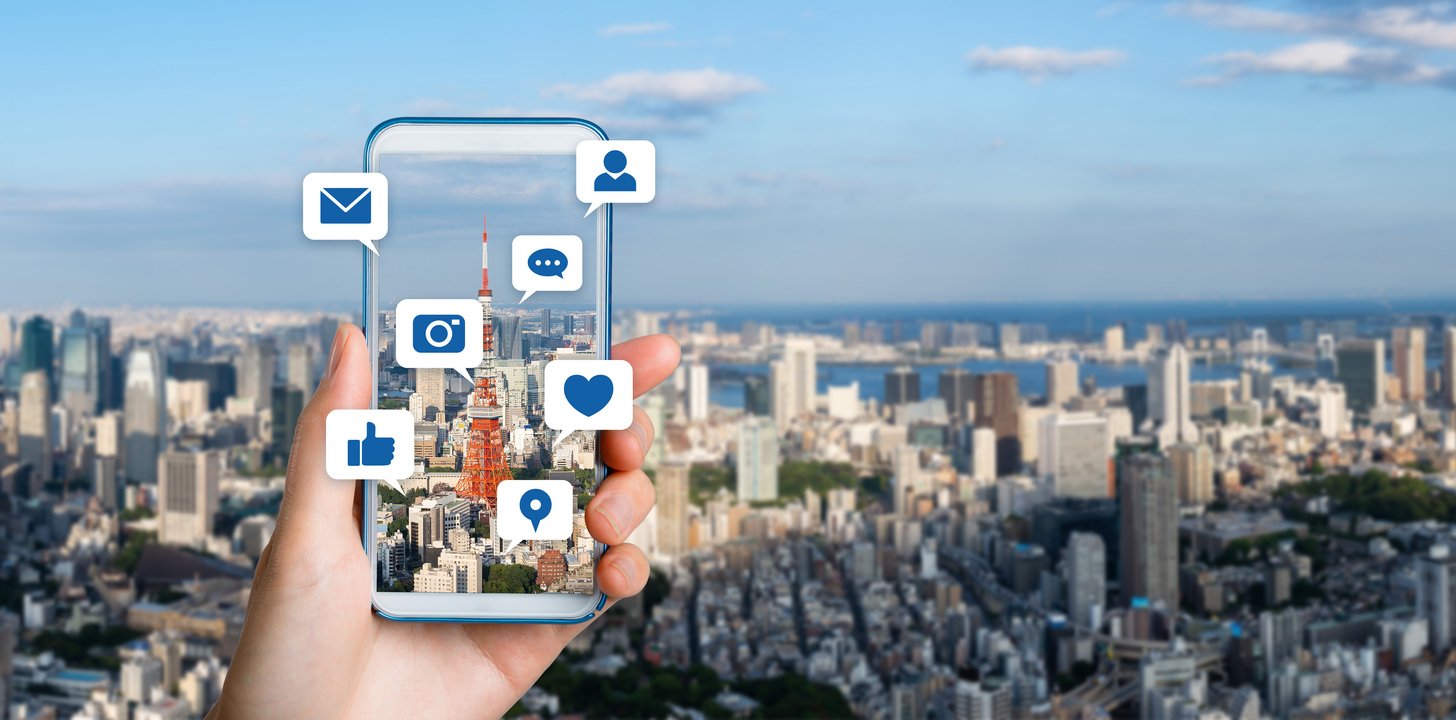 phone taking photo of a view while social media icons pop up