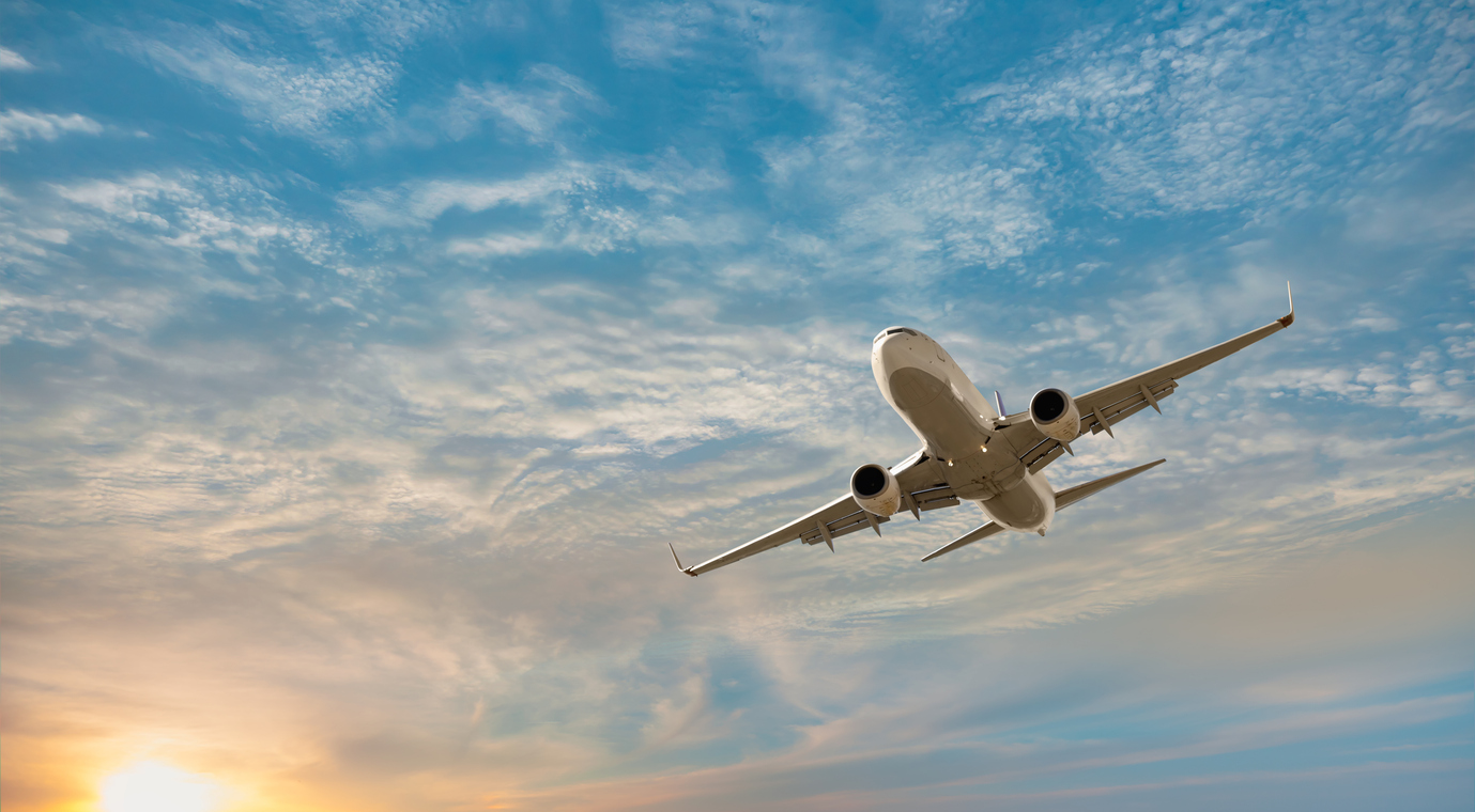 airplane in the sky at sunset
