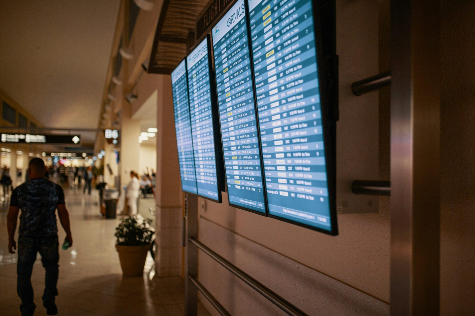 digital screen hanging on the wall in an airport