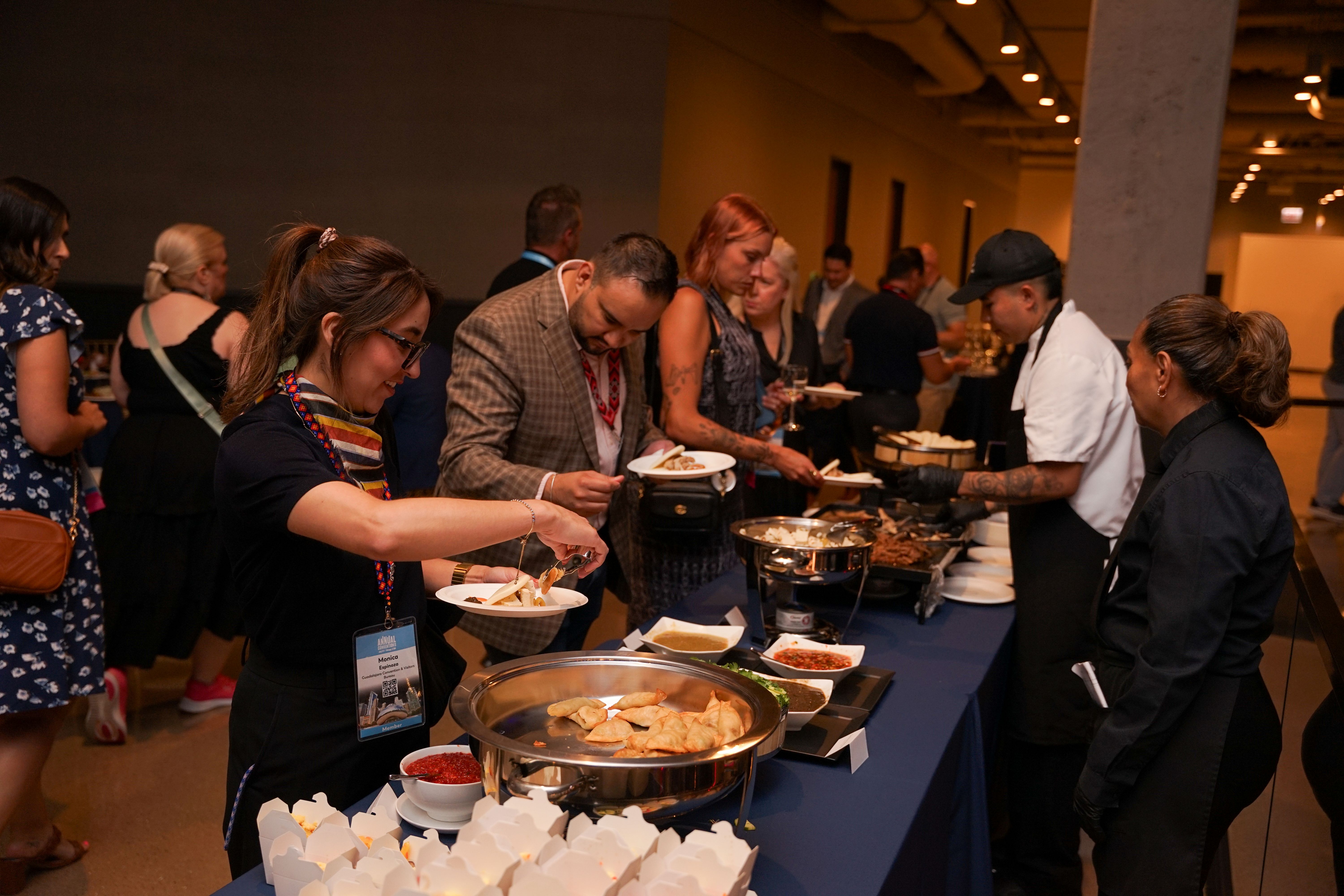 conference attendees serve themselves at the buffet