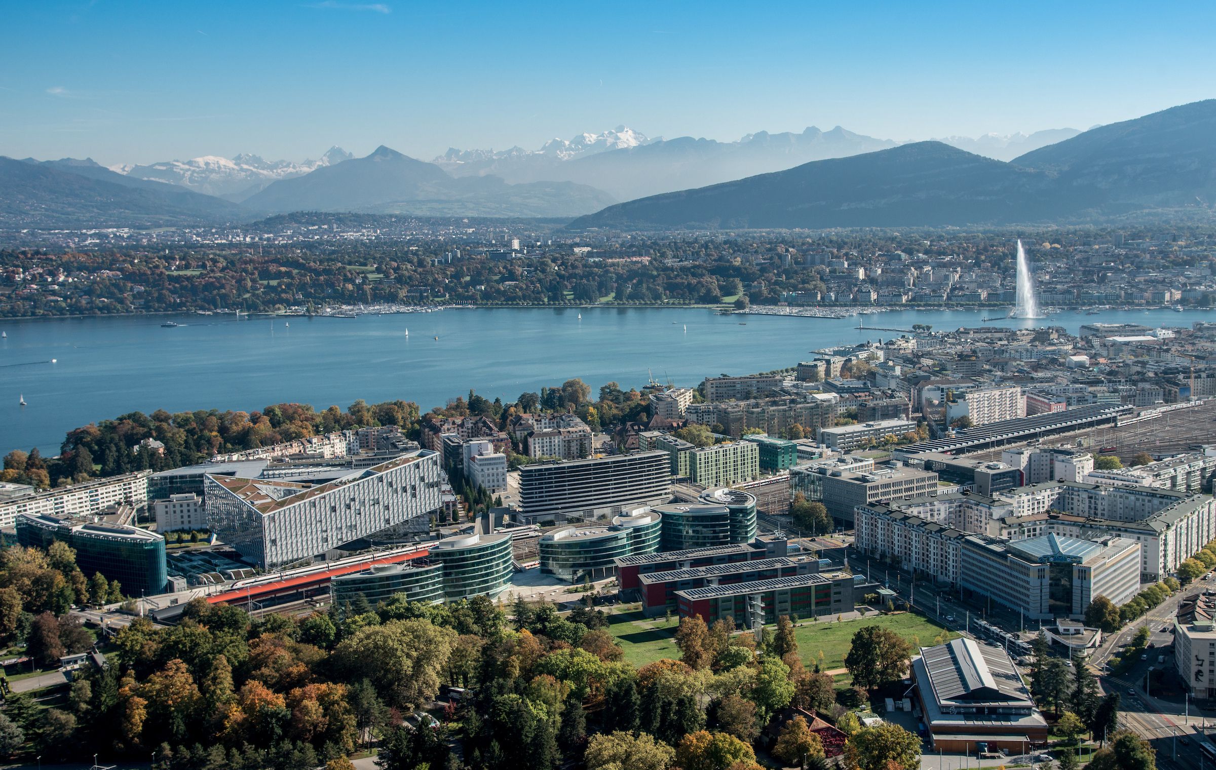 View of Geneva with city in foreground and water and mountains in background