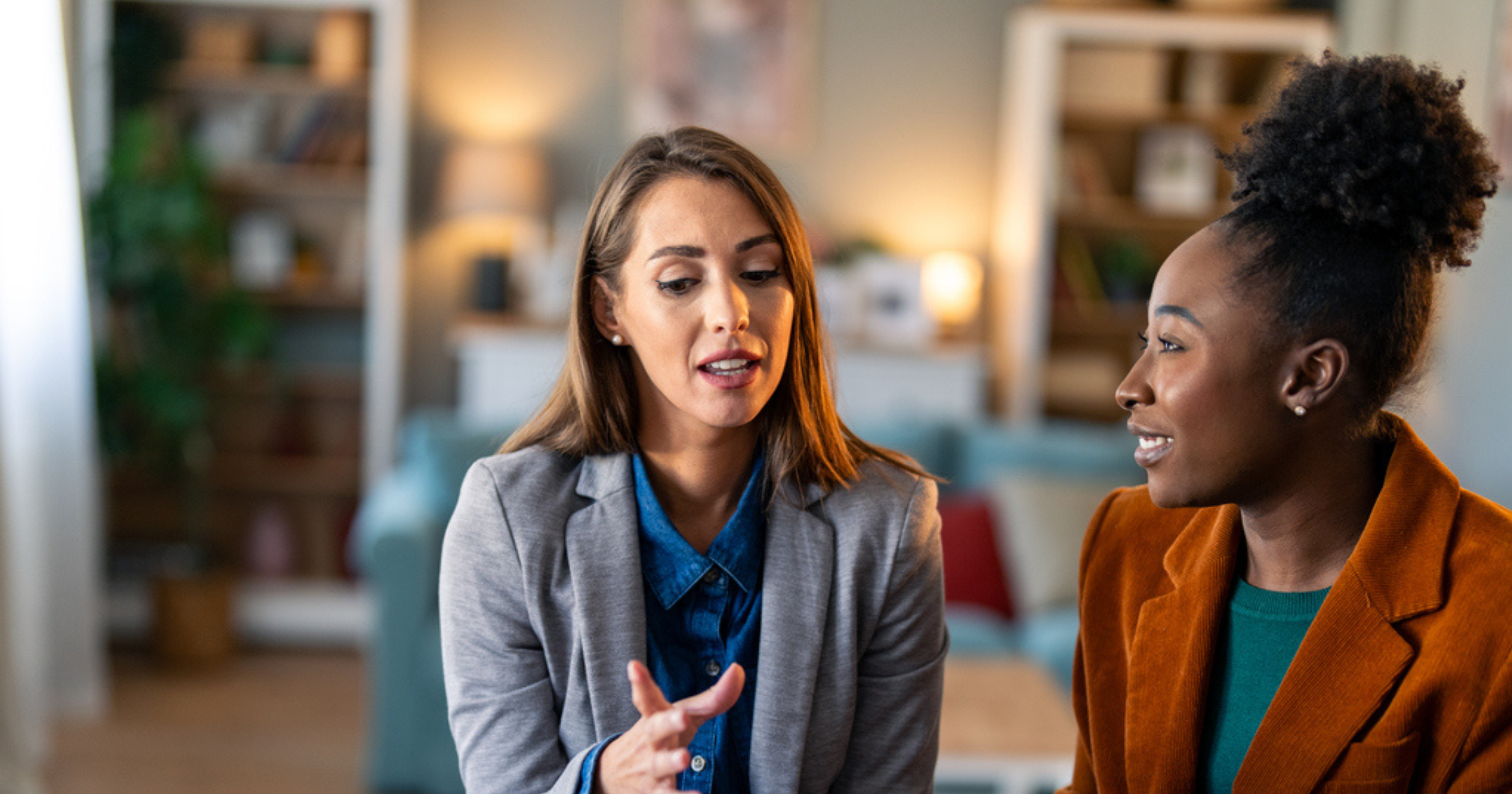 two women speak at work
