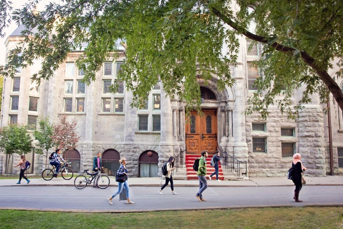 Students walking in front of Redpath Hall in the Spring Valeria Lau at McGill University