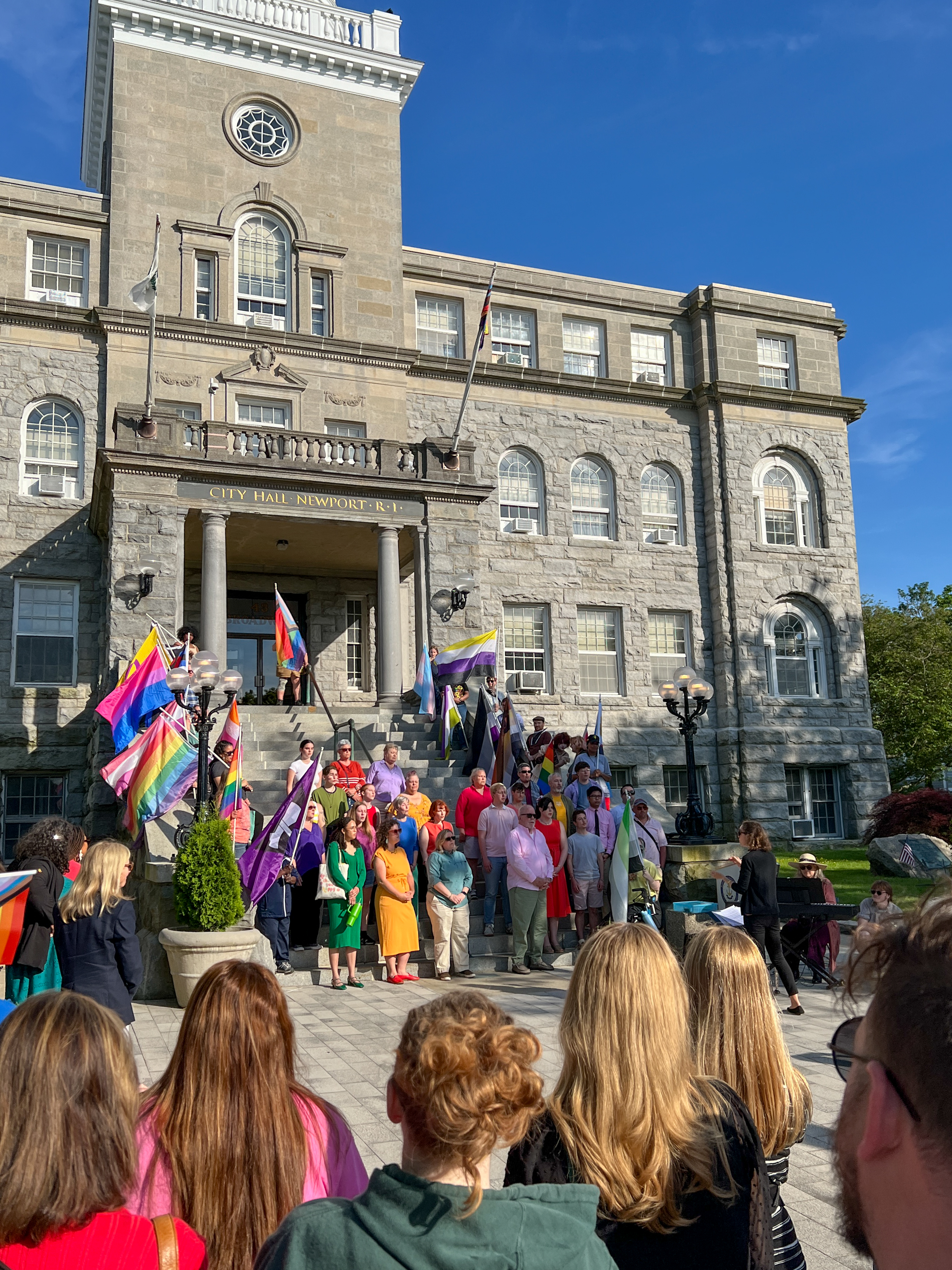 pride flags on the steps of city hall