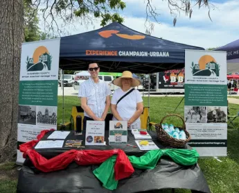 2 workers at the Experience Champaign Urbana booth