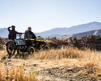 two people overlooking the view of a mountain