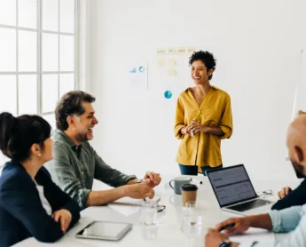 A woman presents to her team in the office