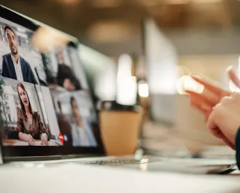 computer screen where four individuals speak on a webinar