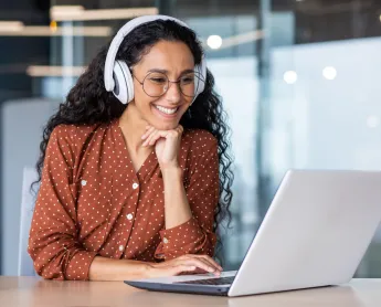 woman smiling looking at laptop