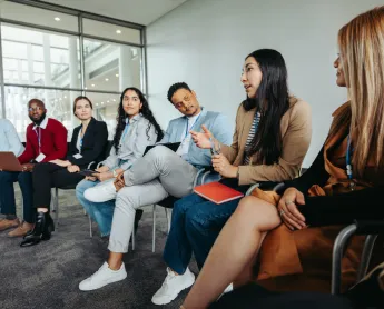 group of coworkers talking in a circle