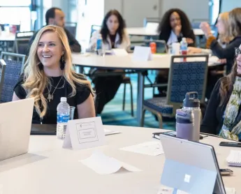 group of event attendees talking at a roundtable