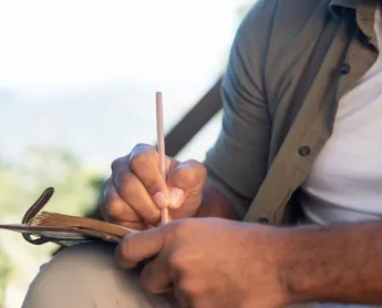 a man writes in a notebook