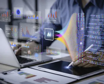 person typing on computer with icons and graphs coming out of the computer