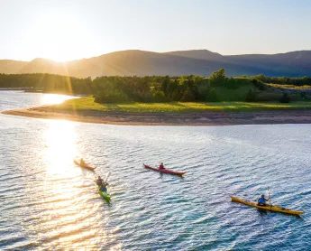 kayakers in the bay at sunset