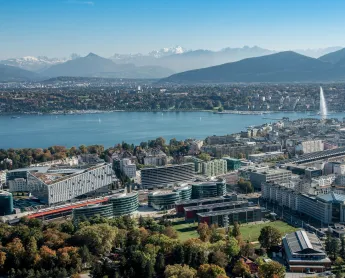 View of Geneva with city in foreground and water and mountains in background
