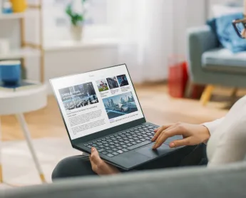 woman reads news on her computer