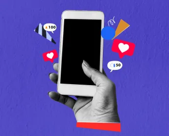 hand holding cell phone with likes and emojis