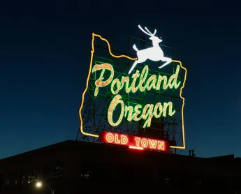 Portland Oregon sign glowing up in the dark