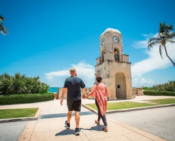 Palm Beach visitors walking across the road