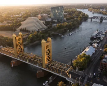 Sunset view of the historic 1935 Tower Bridge and the downtown skyline of Old Sacramento, California, USA.