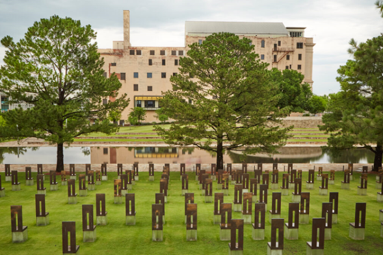 The Field of Empty Chairs fills the foreground, with the Reflecting Pool and Memorial Museum beyond.