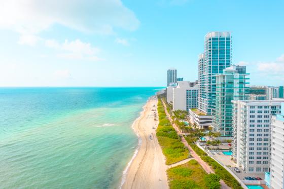 Miami skyline: bright blue ocean on one side and skyscraper buildings on the other