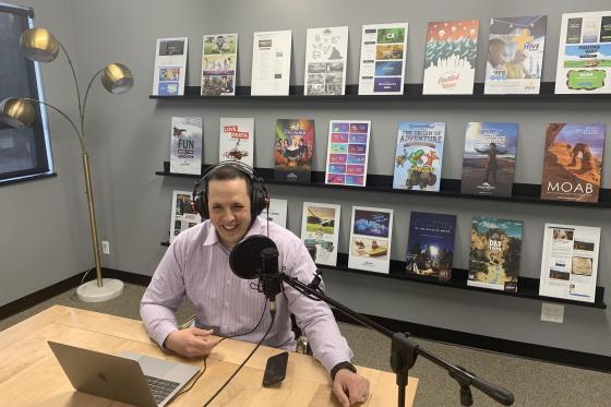 Adam Stoker in conference room recording podcast