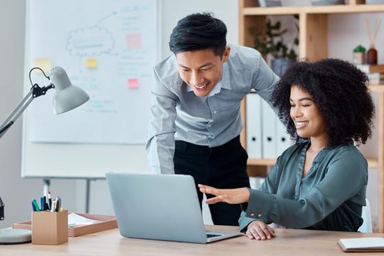 coworkers looking at laptop