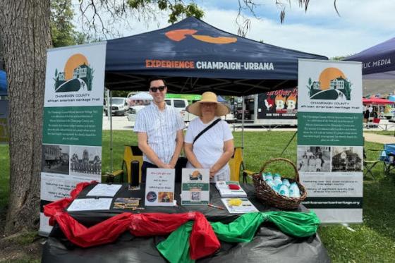 2 workers at the Experience Champaign Urbana booth