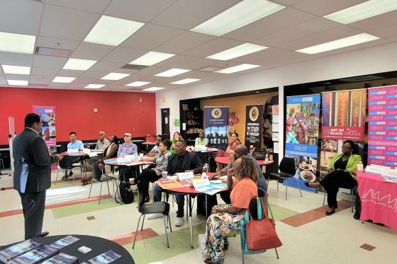 Greater Miami CVB team sitting in a classroom while a speaker presents