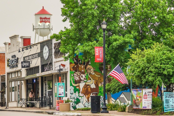 Downtown area with shops and a banner that says Frisco Rail District