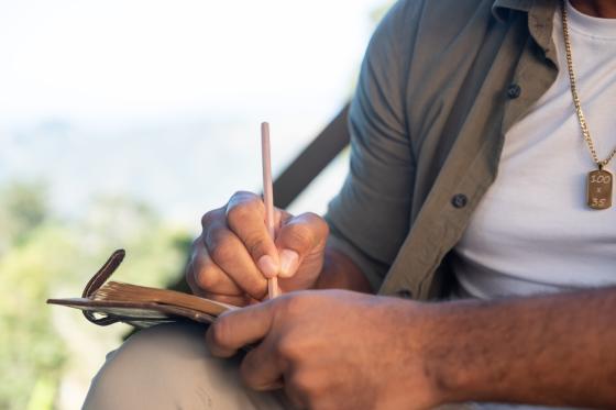 a man writes in a notebook