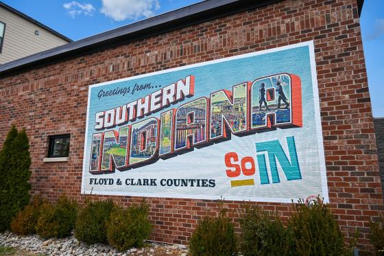 Colorful mural on side of a building that says "Greetings from Southern Indiana"