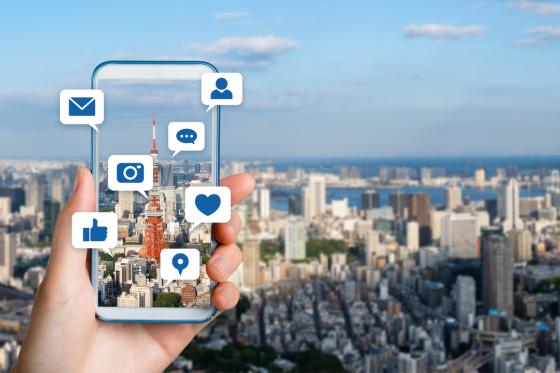 phone taking photo of a view while social media icons pop up