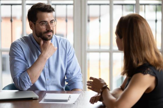 man and woman having a conversation at work
