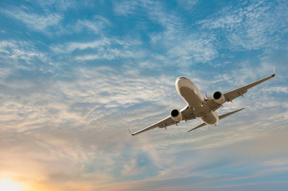 airplane in the sky at sunset