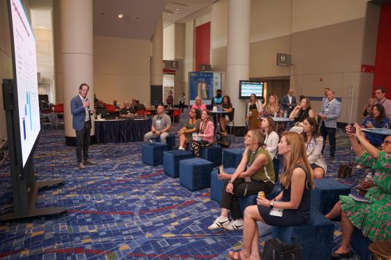 speaker presenting to the crowd of listeners