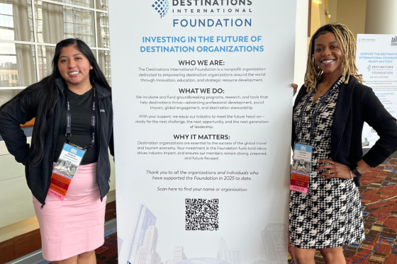 Two HBCU scholars pose in front of a sign at Annual Convention