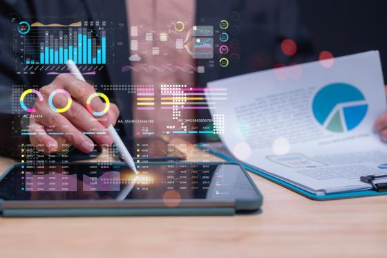 Professional utilizes tablet to analyze data, modern analytics methods through visual representations and charts