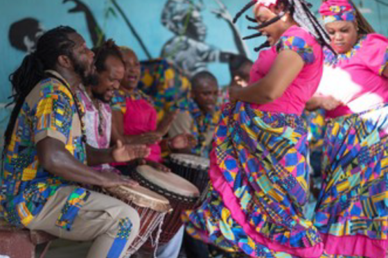 People in bright clothing dancing