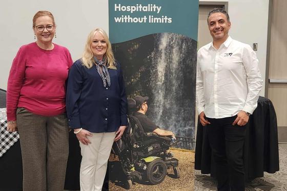 North Alabama team in front of banner that says Hospitality without Limits